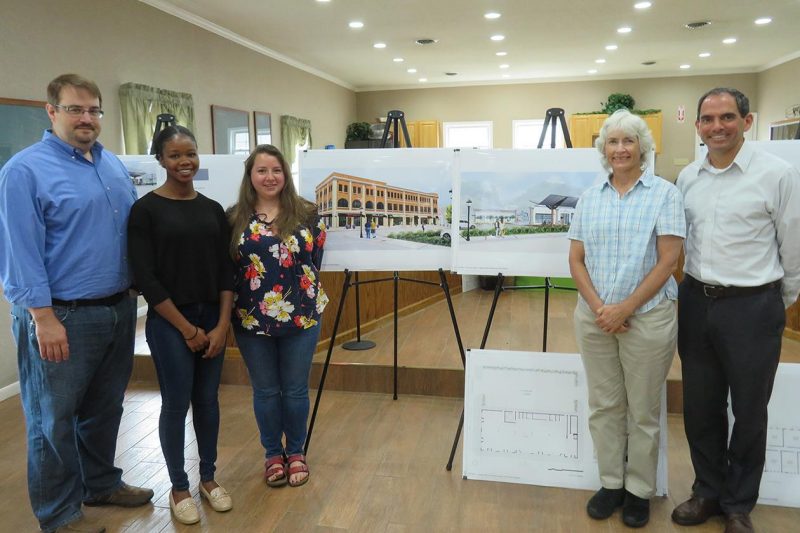 CDAC group including the director, faculty advisor, and students standing in front of final design concepts.