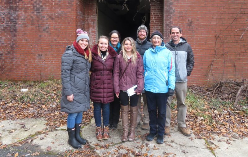 CDAC group with director, staff, and students outside in front of brick building in the winter
